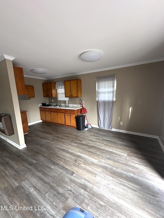 52 Dog Wood Cove Rd, Coffeeville, MS 38922 - kitchen featuring dark wood-style floors, ornamental molding, brown cabinets, and open floor plan