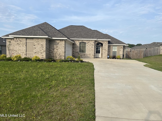 108 Brunswick Cv, Canton, MS 39046 - french country home with brick siding, driveway, roof with shingles, and a garage