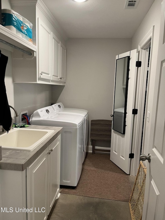 108 Brunswick Cv, Canton, MS 39046 - washroom featuring cabinet space, washing machine and dryer, dark carpet, and baseboards