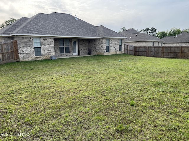 108 Brunswick Cv, Canton, MS 39046 - rear view of property featuring brick siding and roof with shingles