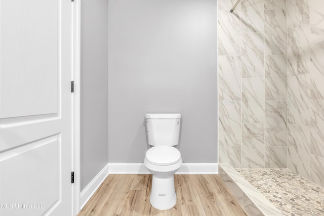 258 Memphis Ave, Holly Springs, MS 38635 - bathroom with tiled shower and wood finished floors