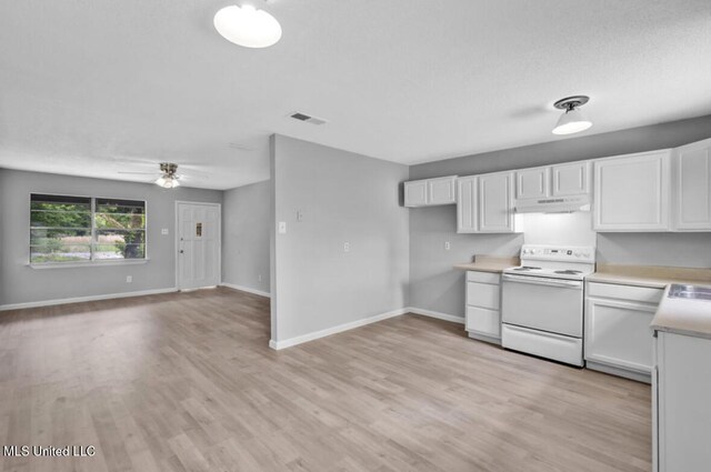 kitchen with under cabinet range hood, white electric range oven, light wood-type flooring, visible vents, and white cabinetry