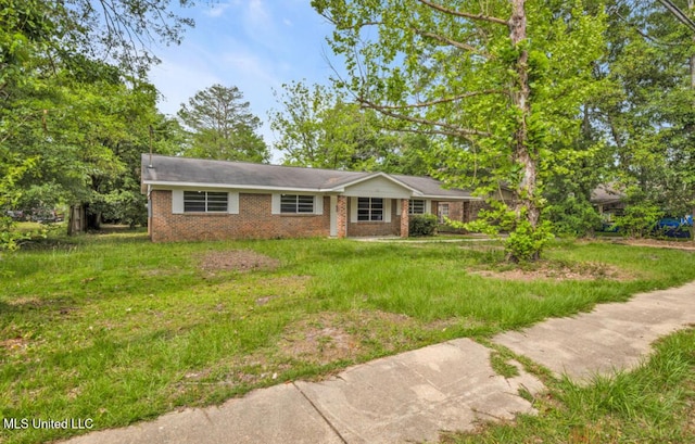 ranch-style house with a front lawn and brick siding