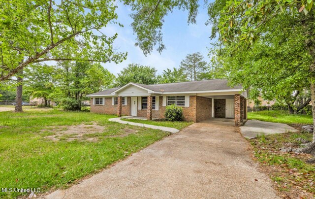 single story home with a front yard, driveway, an attached carport, and brick siding