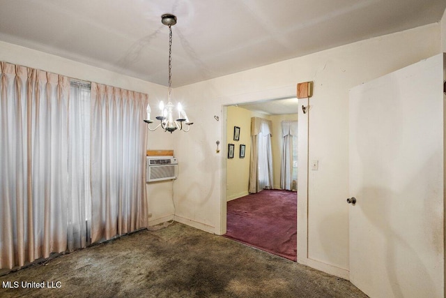 unfurnished dining area featuring dark colored carpet, a chandelier, and cooling unit