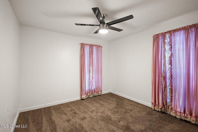 518 W Ash St, Jackson, MS 39203 - unfurnished room featuring a ceiling fan, dark colored carpet, and baseboards