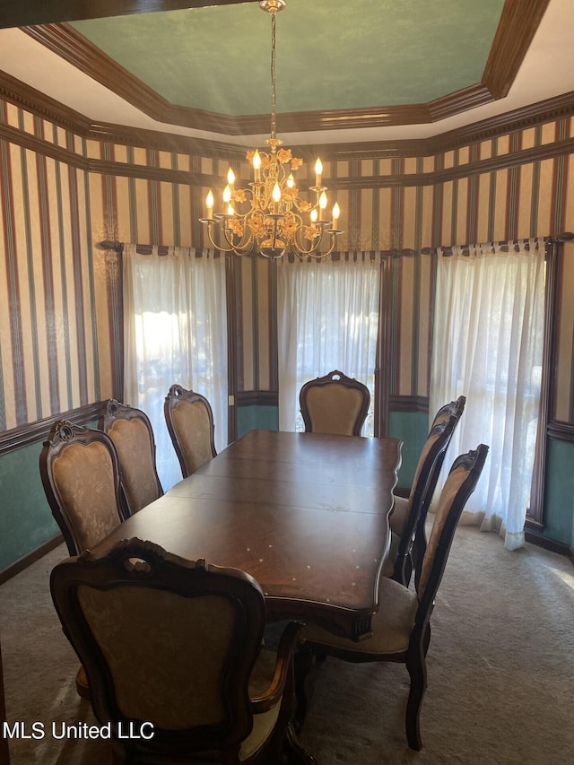 dining space featuring ornamental molding, a healthy amount of sunlight, and carpet