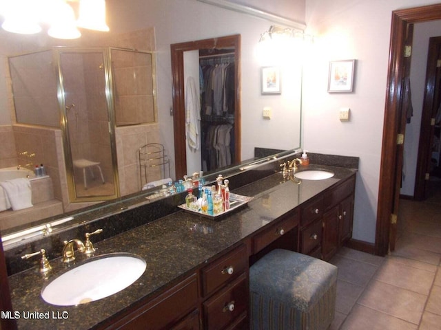 bathroom featuring vanity, plus walk in shower, and tile patterned floors