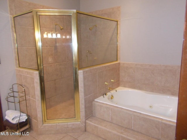 bathroom featuring tile patterned flooring and shower with separate bathtub