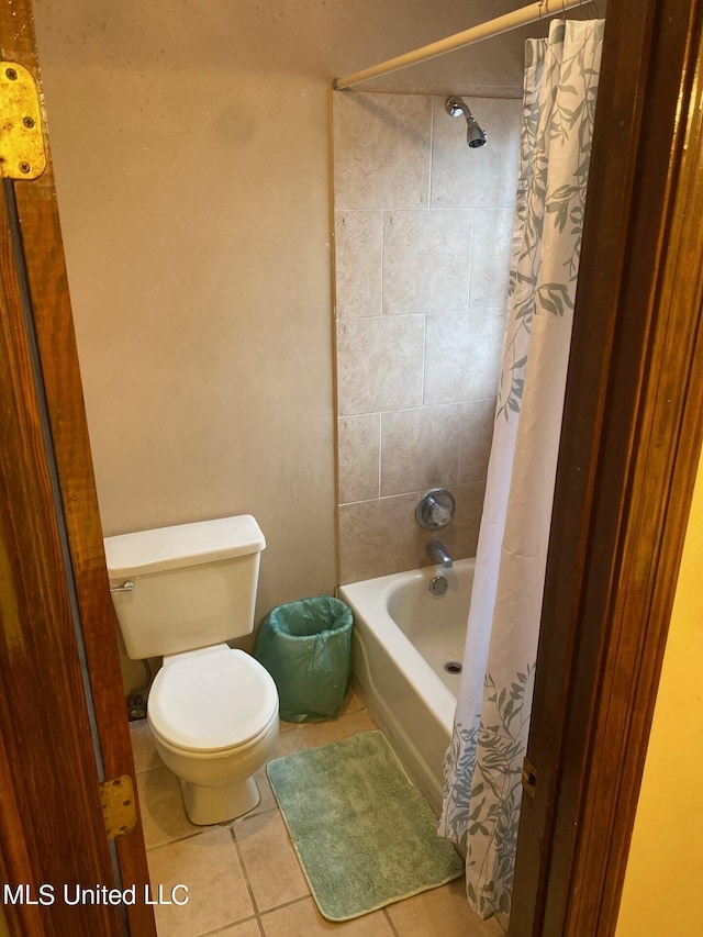 bathroom featuring toilet, shower / bath combo, and tile patterned flooring