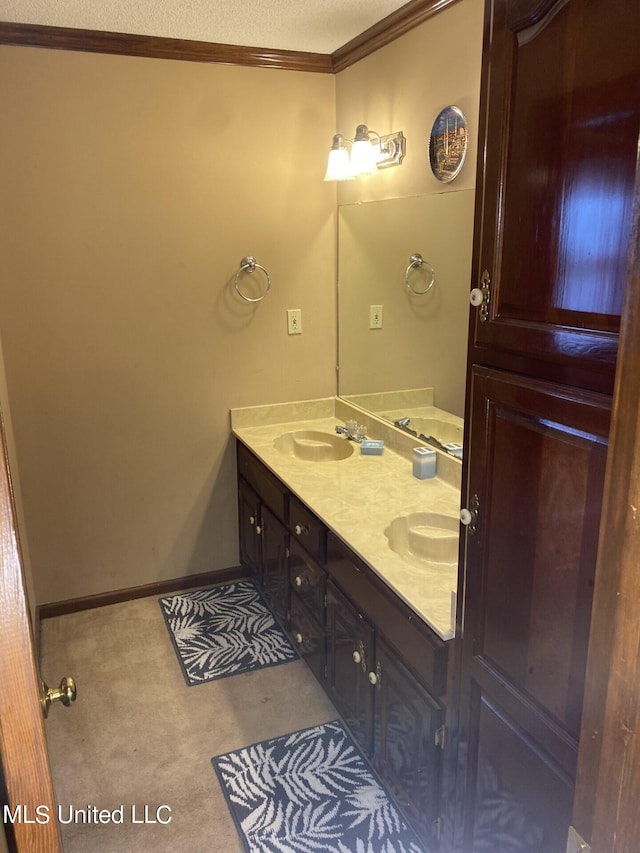 bathroom featuring vanity, crown molding, and a textured ceiling