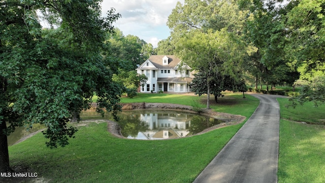 view of property's community with a yard and a water view