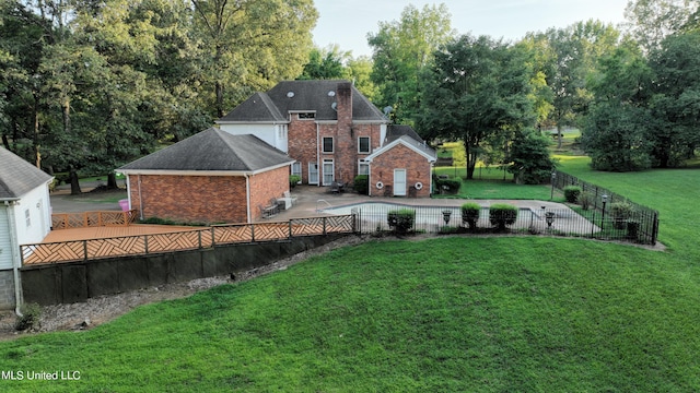 back of property featuring a patio area and a lawn