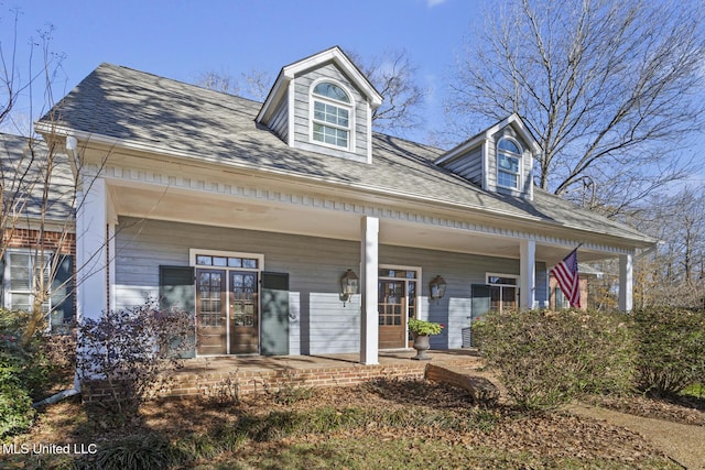 cape cod house featuring covered porch