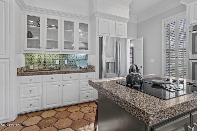 kitchen with white cabinetry, stainless steel fridge, black electric stovetop, and a center island with sink