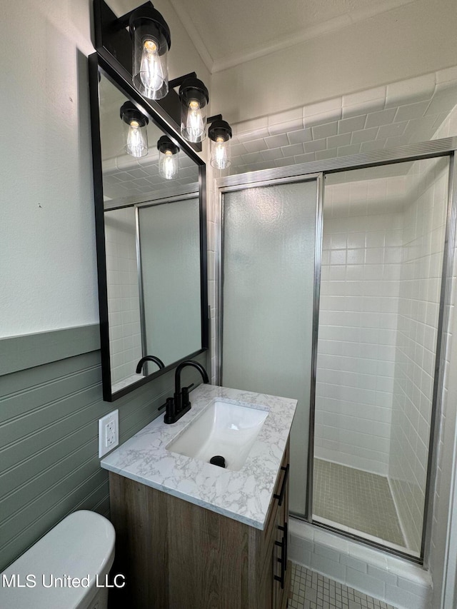 bathroom featuring vanity, toilet, tile patterned flooring, and an enclosed shower