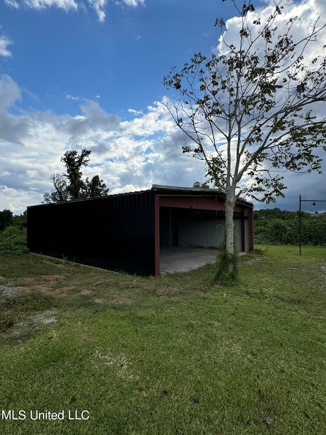 view of outdoor structure featuring a lawn