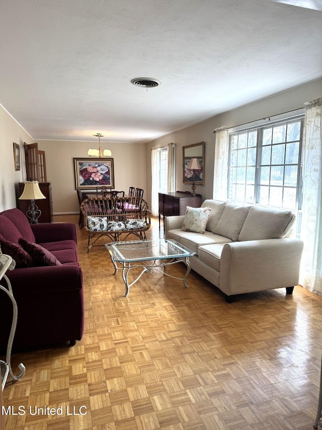 living area featuring visible vents and a textured ceiling