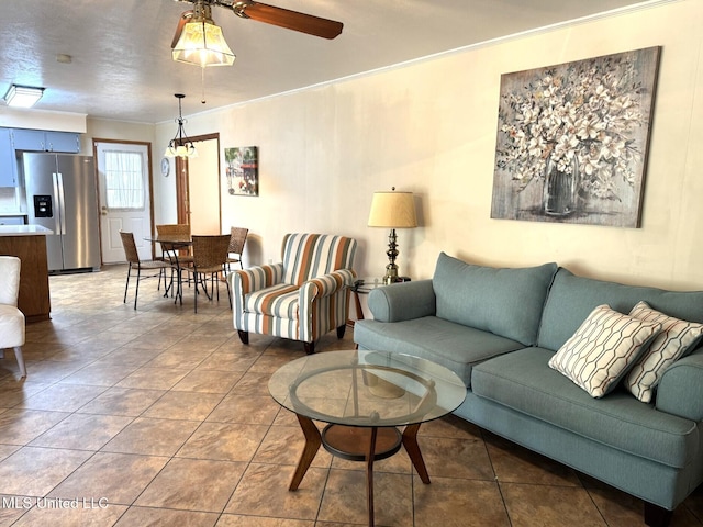 tiled living room featuring crown molding and ceiling fan