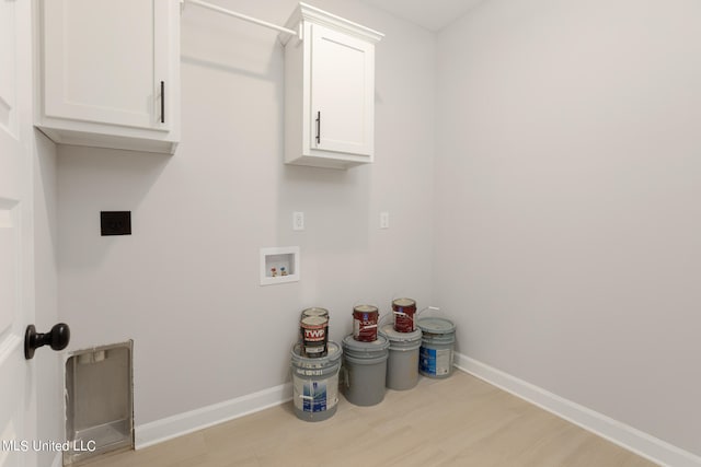 washroom with cabinets, hookup for a washing machine, light wood-type flooring, and electric dryer hookup