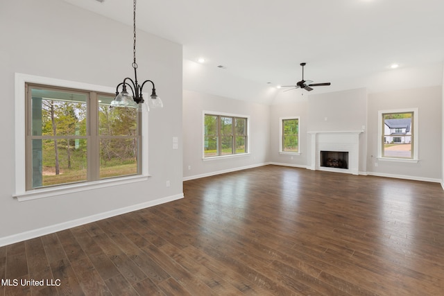 unfurnished living room with ceiling fan with notable chandelier, vaulted ceiling, and dark hardwood / wood-style floors