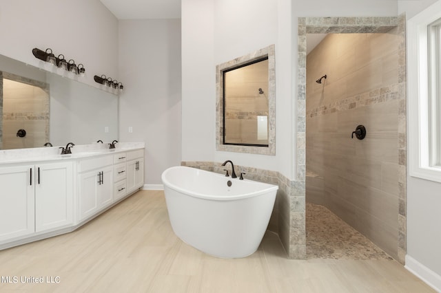 bathroom with vanity and separate shower and tub