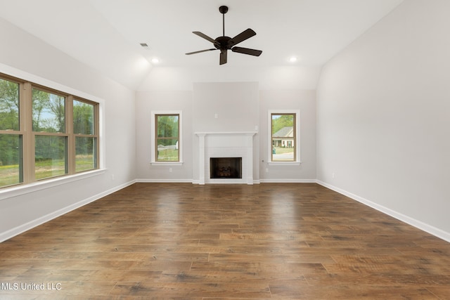 unfurnished living room with a healthy amount of sunlight, lofted ceiling, and dark hardwood / wood-style flooring