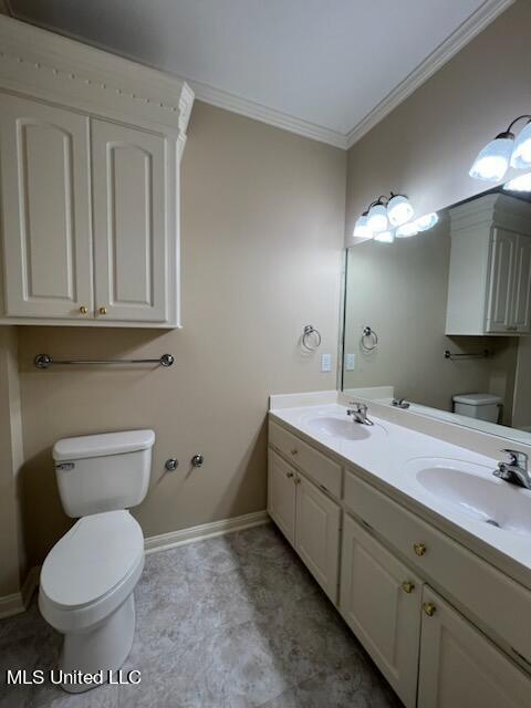 bathroom with vanity, toilet, and ornamental molding