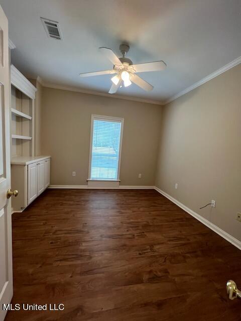 spare room featuring ceiling fan, crown molding, and dark hardwood / wood-style flooring