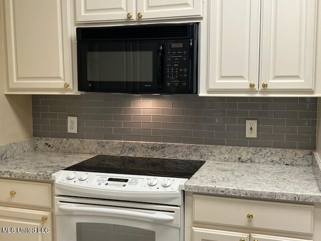 kitchen with light stone counters, tasteful backsplash, white range with electric stovetop, and white cabinets