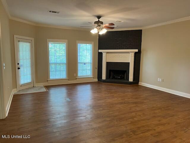 unfurnished living room with ornamental molding, ceiling fan, and dark hardwood / wood-style flooring