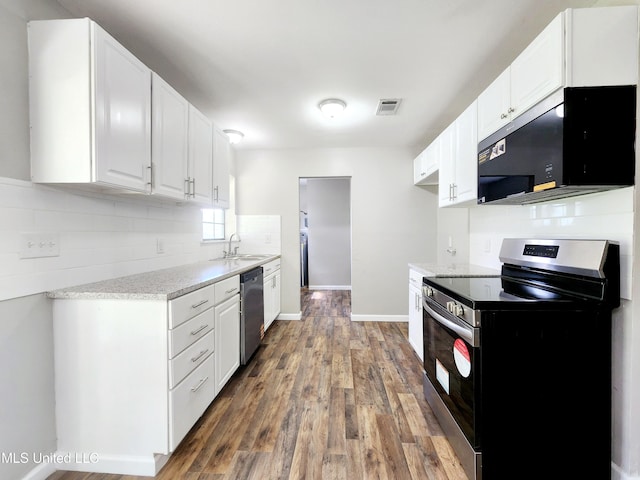 9108 Moser Ave, Vancleave, MS 39565 - kitchen with stainless steel appliances, a sink, wood finished floors, and white cabinets