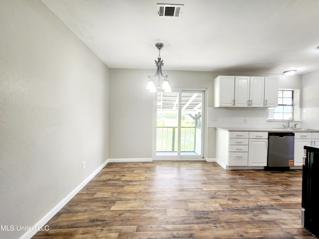 9108 Moser Ave, Vancleave, MS 39565 - kitchen with stainless steel dishwasher, white cabinets, a sink, baseboards, and dark wood-type flooring