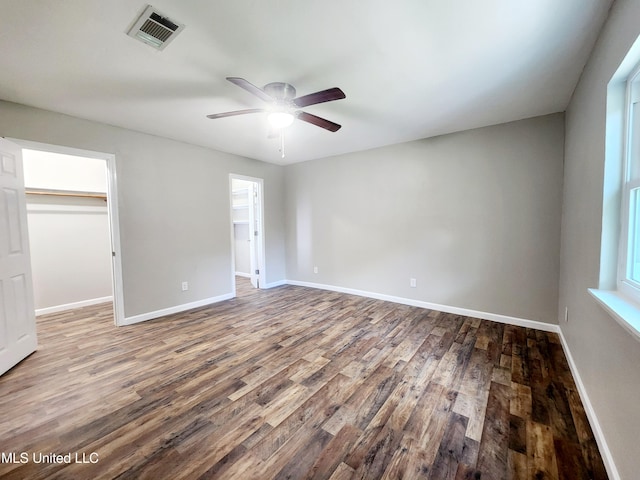 9108 Moser Ave, Vancleave, MS 39565 - unfurnished bedroom with a walk in closet, wood finished floors, and baseboards