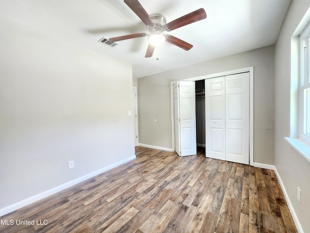 9108 Moser Ave, Vancleave, MS 39565 - unfurnished bedroom featuring wood finished floors, a closet, baseboards, and a ceiling fan