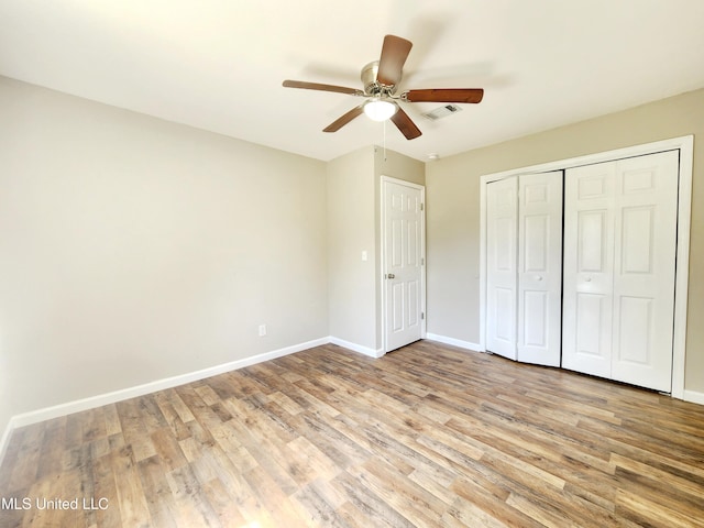 9108 Moser Ave, Vancleave, MS 39565 - unfurnished bedroom featuring wood finished floors, baseboards, a closet, and ceiling fan
