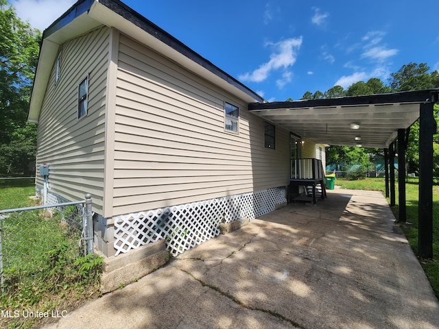 9108 Moser Ave, Vancleave, MS 39565 - view of home's exterior with concrete driveway, an attached carport, and fence
