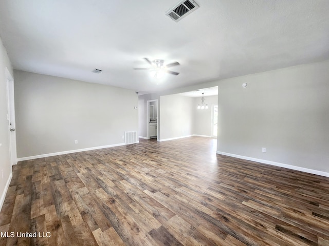 9108 Moser Ave, Vancleave, MS 39565 - empty room with a chandelier, dark wood-style flooring, a ceiling fan, and baseboards