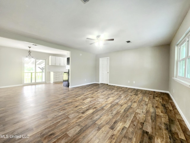 9108 Moser Ave, Vancleave, MS 39565 - unfurnished living room featuring wood finished floors, a ceiling fan, and baseboards