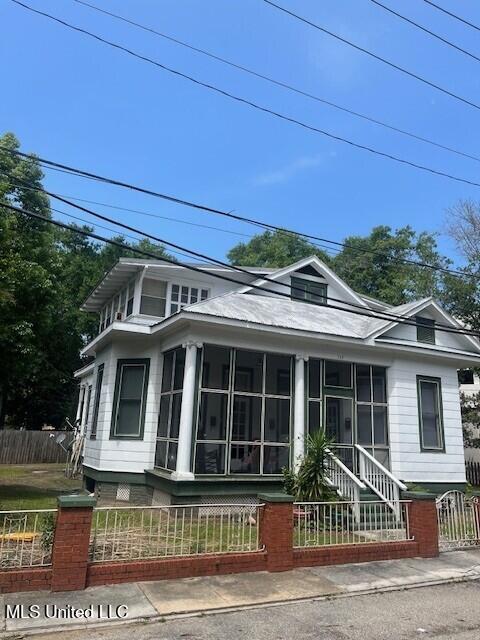 139 Fayard St, Biloxi, MS 39530 - view of front of property with a fenced front yard and a sunroom
