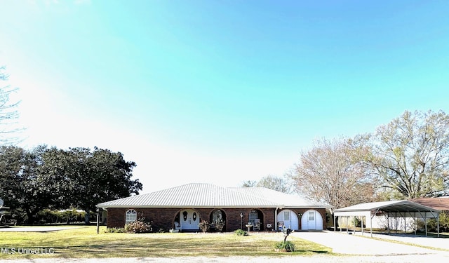 view of front facade with a front yard and a carport