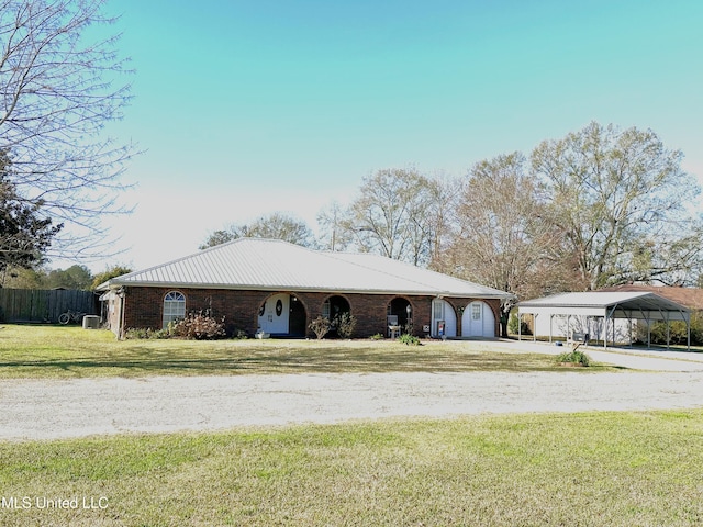 view of front of property with a front lawn, a garage, and a carport