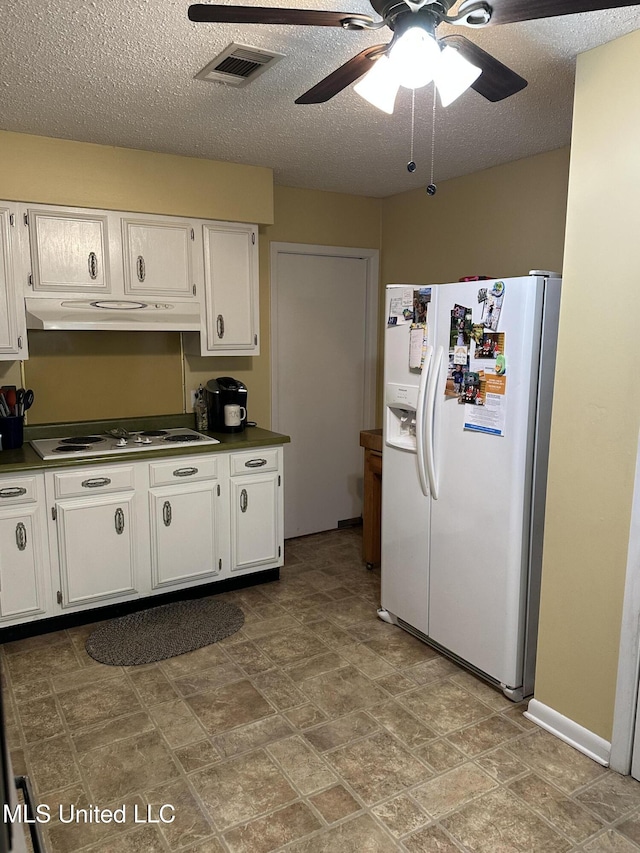 kitchen featuring a textured ceiling, white cabinetry, ceiling fan, and white appliances