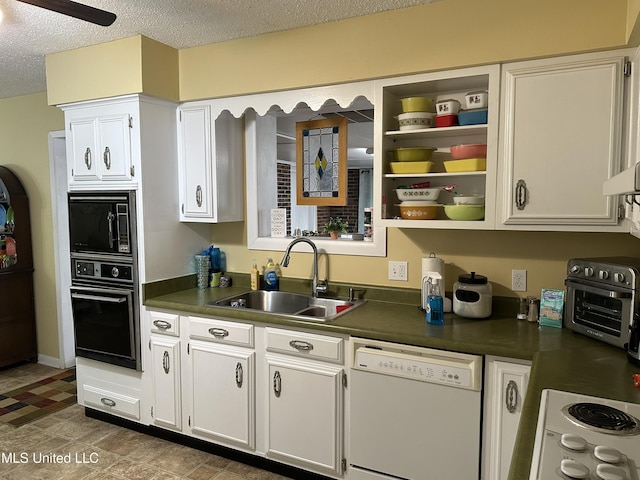 kitchen with sink, white cabinets, black appliances, and a textured ceiling