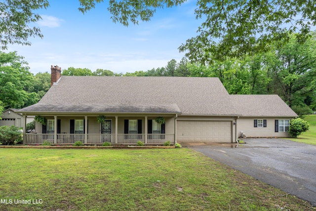 3590 Shady Oaks Dr, Olive Branch, MS 38654 - view of front of property with covered porch, a chimney, driveway, a front yard, and a garage