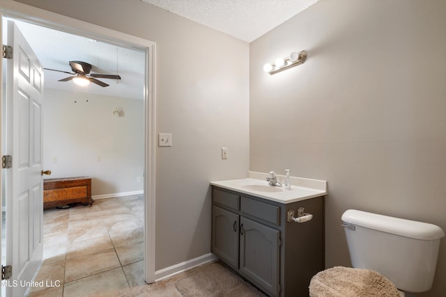 3590 Shady Oaks Dr, Olive Branch, MS 38654 - bathroom featuring ceiling fan, vanity, a textured ceiling, toilet, and baseboards