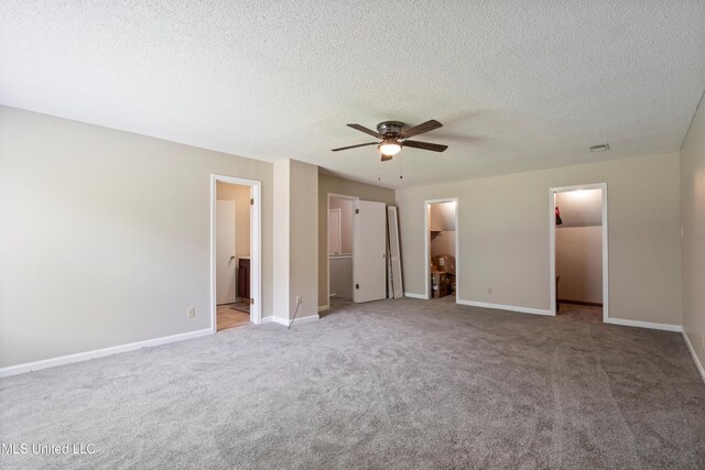 3590 Shady Oaks Dr, Olive Branch, MS 38654 - unfurnished bedroom featuring a spacious closet, carpet, baseboards, and a textured ceiling