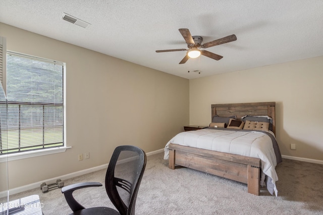 3590 Shady Oaks Dr, Olive Branch, MS 38654 - bedroom featuring multiple windows, light carpet, a ceiling fan, a textured ceiling, and baseboards