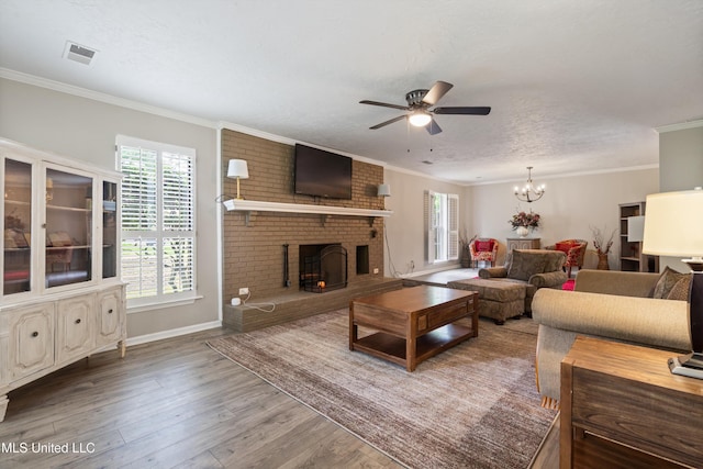 3590 Shady Oaks Dr, Olive Branch, MS 38654 - living room with ceiling fan, healthy amount of natural light, wood finished floors, crown molding, and a fireplace