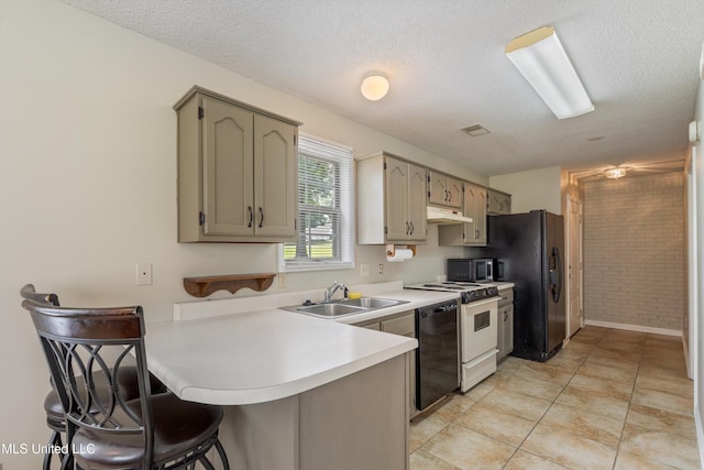 3590 Shady Oaks Dr, Olive Branch, MS 38654 - kitchen with a sink, black appliances, under cabinet range hood, a peninsula, and brick wall